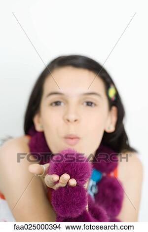 Teenage girl wearing boa, blowing kiss at camera View Large Photo Image Picture - Teenage girl wearing boa, blowing kiss at camera. Fotosearch