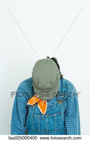 Teenage girl wearing hat, head down View Large Photo Image Stock Image - Teenage girl wearing hat, head down. Fotosearch