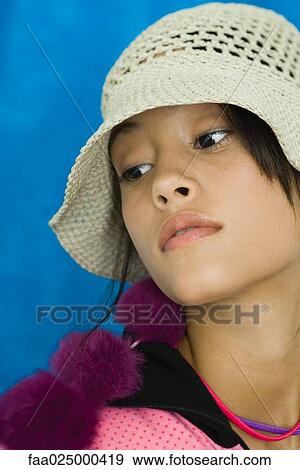 Teenage girl wearing hat, looking away, portrait View Large Photo Image Stock Photo - Teenage girl wearing hat, looking away, portrait. Fotosearch