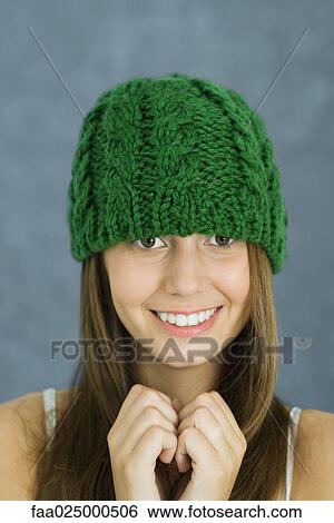 Teenage girl wearing knit hat, smiling at camera, clasped hands View Large Photo Image Stock Photograph - Teenage girl wearing knit hat, smiling at camera, clasped hands. Fotosearch