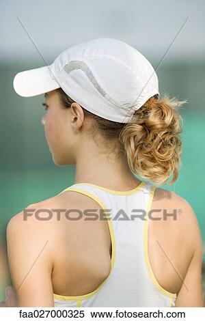 Teenage girl wearing tank top and cap, rear view View Large Photo Image Stock Photography - Teenage girl wearing tank top and cap, rear view. Fotosearch