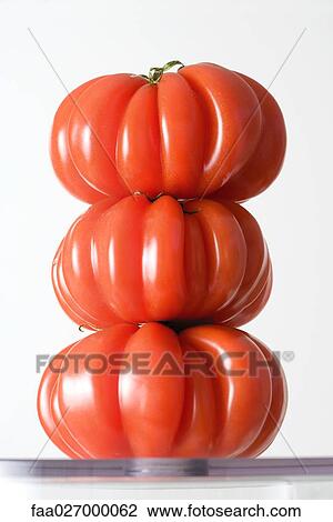 Three heirloom tomatoes stacked on top of one another, close-up View Large Photo Image Stock Image - Three heirloom tomatoes stacked on top of one another, close-up. Fotosearch
