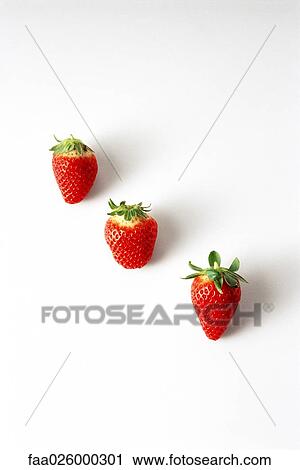 Three strawberries in a diagonal row View Large Photo Image Stock Image - Three strawberries in a diagonal row. Fotosearch