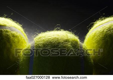 Stock Photo - Three tennis balls, extreme close-up. Fotosearch