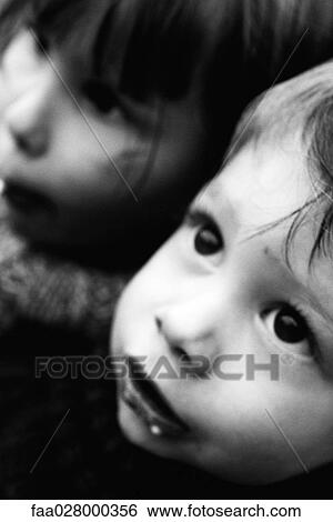 Two children looking up, portrait, close-up, cropped View Large Photo Image Stock Photograph - Two children looking up, portrait, close-up, cropped. Fotosearch