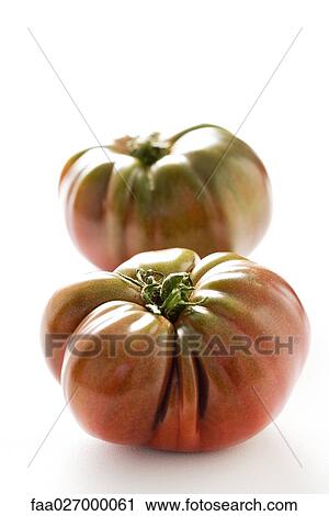 Two heirloom tomatoes, close-up View Large Photo Image Stock Image - Two heirloom tomatoes, close-up. Fotosearch