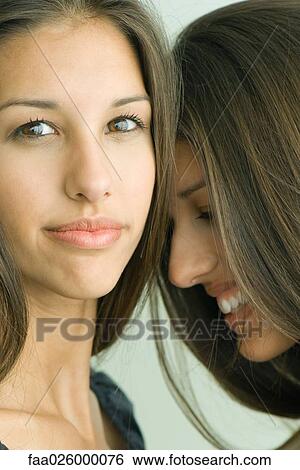 Two twin teenage sisters smiling, one looking at camera View Large Photo Image Stock Photograph - Two twin teenage sisters smiling, one looking at camera. Fotosearch