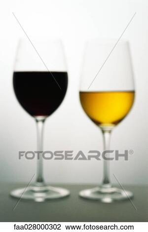 Two wine glasses with red and white wines, defocused View Large Photo Image Stock Image - Two wine glasses with red and white wines, defocused. Fotosearch