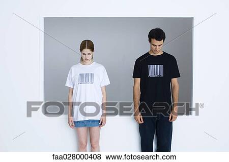 Two young adults wearing tee-shirts printed with bar codes, both looking down View Large Photo Image Stock Photo - Two young adults wearing tee-shirts printed with bar codes, both looking down. Fotosearch