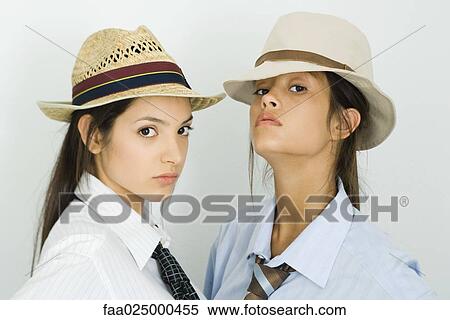 Two young female friends wearing hats and ties, both looking at camera View Large Photo Image Stock Photography - Two young female friends wearing hats and ties, both looking at camera. Fotosearch