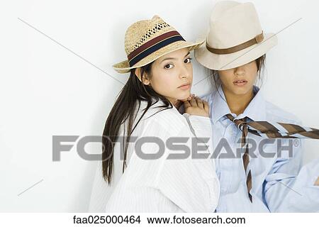 Two young females dressed in men's clothing, one looking at camera View Large Photo Image Picture - Two young females dressed in men's clothing, one looking at camera. Fotosearch