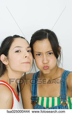 Two young friends making faces at camera View Large Photo Image Picture - Two young friends making faces at camera. Fotosearch