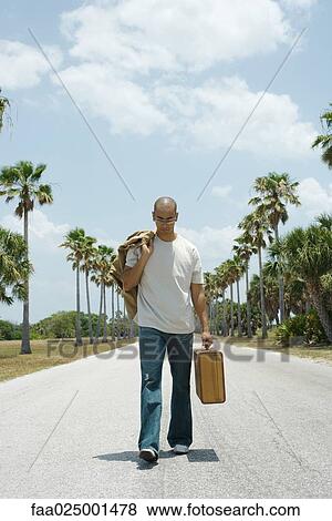 walking, suitcase, carrying, hitchhiking, looking down, mid adult men View Large Photo Image Stock Photo - walking, suitcase, carrying, hitchhiking, looking down, mid adult men. Fotosearch