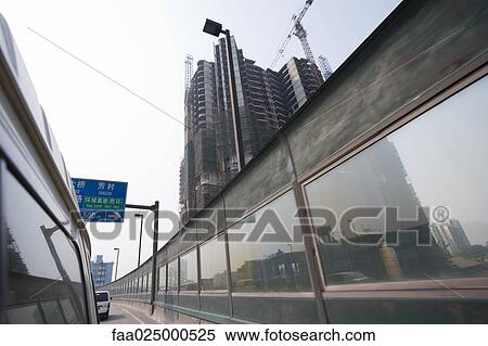 Wall on side of road, viewed from vehicle, high rise under construction in background View Large Photo Image Stock Photography - Wall on side of road, viewed from vehicle, high rise under construction in background. Fotosearch