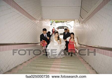 Wedding procession walking up stairs, high angle view View Large Photo Image Stock Photography - Wedding procession walking up stairs, high angle view. Fotosearch