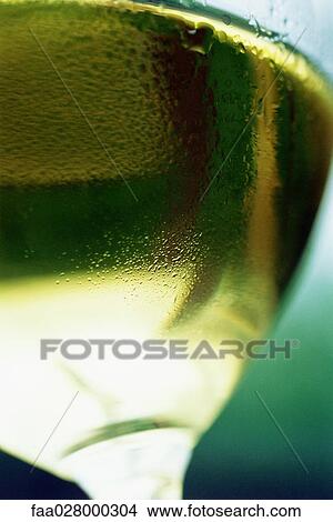 White wine glass with condensation, extreme close-up, low angle view View Large Photo Image Picture - White wine glass with condensation, extreme close-up, low angle view. Fotosearch