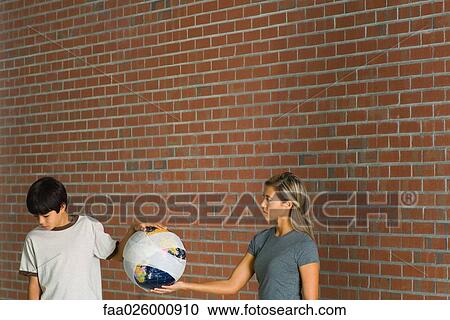 Woman and boy holding globe wrapped in bandages, woman looking at boy, boy looking down View Large Photo Image Stock Image - Woman and boy holding globe wrapped in bandages, woman looking at boy, boy looking down. Fotosearch