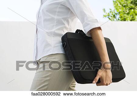 Woman carrying laptop bag, cropped view of mid section View Large Photo Image Stock Image - Woman carrying laptop bag, cropped view of mid section. Fotosearch