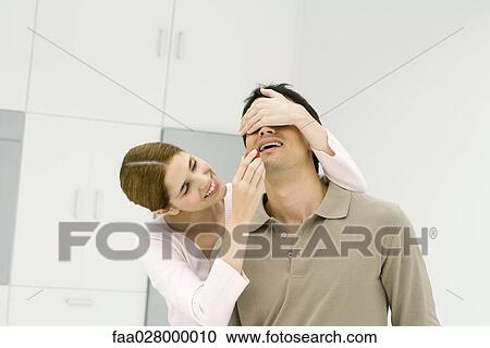 Woman covering man's eyes with her hand, feeding him a fresh strawberry View Large Photo Image Stock Image - Woman covering man's eyes with her hand, feeding him a fresh strawberry. Fotosearch