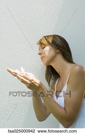 Woman holding fake butterflies on hand View Large Photo Image Stock Image - Woman holding fake butterflies on hand. Fotosearch