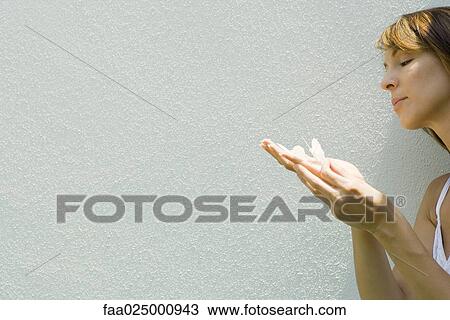 Woman holding fake butterflies on hand View Large Photo Image Stock Image - Woman holding fake butterflies on hand. Fotosearch