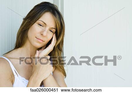 Woman holding head, looking down View Large Photo Image Stock Image - Woman holding head, looking down. Fotosearch