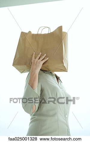Woman holding paper bag on shoulder, head hidden View Large Photo Image Stock Photo - Woman holding paper bag on shoulder, head hidden. Fotosearch