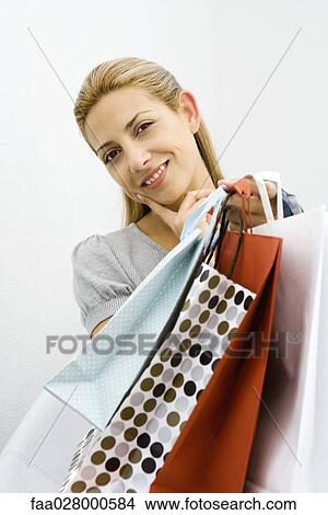 Woman holding several shopping bags View Large Photo Image Picture - Woman holding several shopping bags. Fotosearch