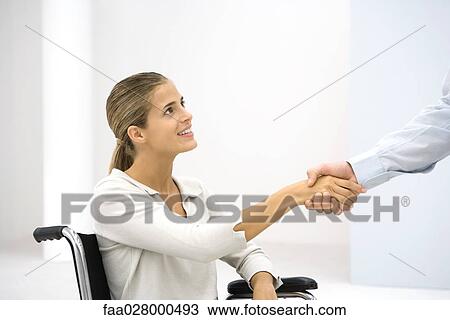 Woman in wheelchair shaking hands with businessman, cropped View Large Photo Image Stock Image - Woman in wheelchair shaking hands with businessman, cropped. Fotosearch