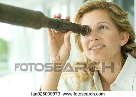 Woman looking through telescope, smiling, close-up View Large Photo Image Stock Image - Woman looking through telescope, smiling, close-up. Fotosearch