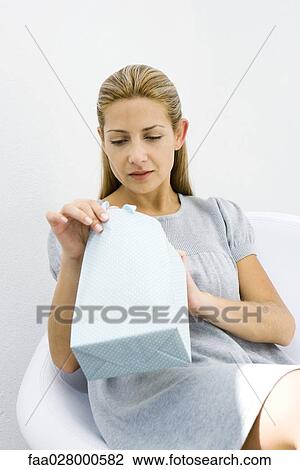 Woman opening gift bag View Large Photo Image Stock Image - Woman opening gift bag. Fotosearch