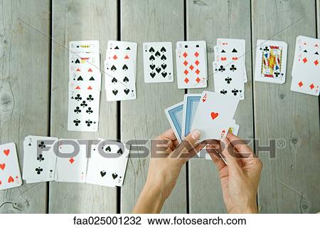 Woman playing solitaire, cropped view of hands and cards View Large Photo Image Stock Image - Woman playing solitaire, cropped view of hands and cards. Fotosearch