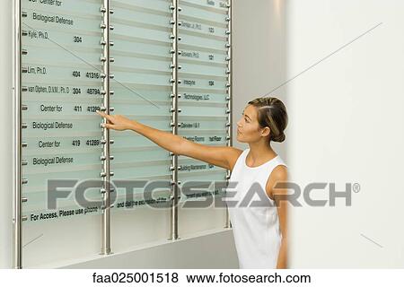 woman, pointing, arms out, looking away, young women, building directory, indication View Large Photo Image Stock Photo - woman, pointing, arms out, looking away, young women, building directory, indication. Fotosearch
