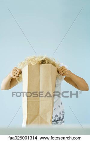 Woman putting head into paper grocery bag View Large Photo Image Picture - Woman putting head into paper grocery bag. Fotosearch