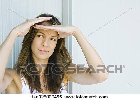 Woman shading eyes, looking away, close-up View Large Photo Image Stock Photography - Woman shading eyes, looking away, close-up. Fotosearch