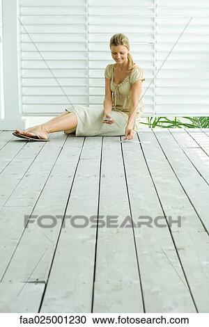 Woman sitting on deck playing solitaire, full length View Large Photo Image Stock Image - Woman sitting on deck playing solitaire, full length. Fotosearch