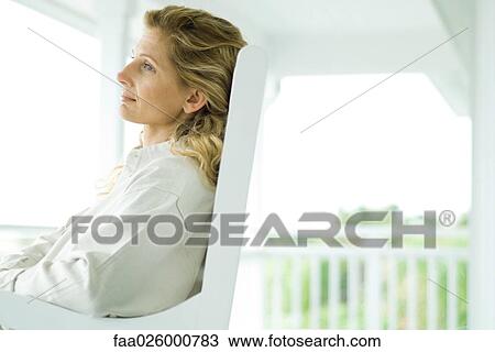 Woman sitting on porch, side view View Large Photo Image Stock Image - Woman sitting on porch, side view. Fotosearch