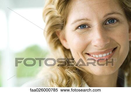 Woman smiling at camera, close-up View Large Photo Image Stock Photography - Woman smiling at camera, close-up. Fotosearch