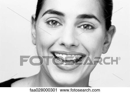 Woman smiling at camera, portrait, close-up View Large Photo Image Stock Image - Woman smiling at camera, portrait, close-up. Fotosearch