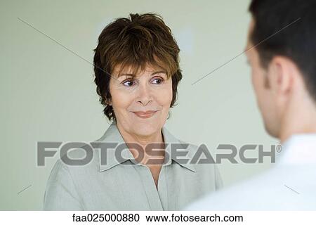 Woman smiling, looking away, over the shoulder view View Large Photo Image Stock Image - Woman smiling, looking away, over the shoulder view. Fotosearch
