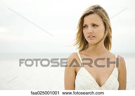Woman standing on beach, head and shoulders View Large Photo Image Stock Image - Woman standing on beach, head and shoulders. Fotosearch
