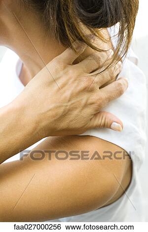 Woman touching the nape of her neck, side view, cropped View Large Photo Image Stock Photograph - Woman touching the nape of her neck, side view, cropped. Fotosearch