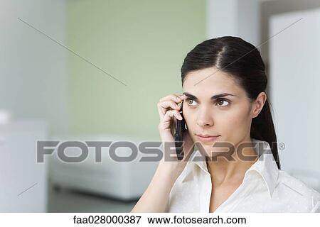 Woman using cell phone, looking away View Large Photo Image Stock Photo - Woman using cell phone, looking away. Fotosearch