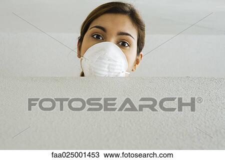 Woman wearing pollution mask, looking over ledge at camera View Large Photo Image Stock Image - Woman wearing pollution mask, looking over ledge at camera. Fotosearch