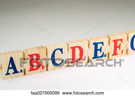 Wooden alphabet blocks in a row, close-up View Large Photo Image Stock Photography - Wooden alphabet blocks in a row, close-up. Fotosearch