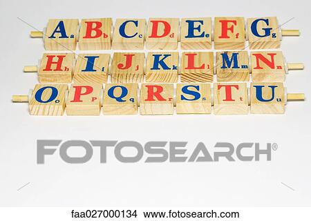 Picture - Wooden alphabet blocks in rows, close-up. Fotosearch