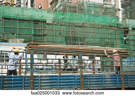 Workers at construction site View Large Photo Image Stock Image - Workers at construction site. Fotosearch