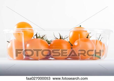 Yellow vine tomatoes in plastic container, close-up View Large Photo Image Stock Image - Yellow vine tomatoes in plastic container, close-up. Fotosearch