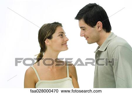 Young couple face to face, smiling at each other, portrait View Large Photo Image Stock Image - Young couple face to face, smiling at each other, portrait. Fotosearch