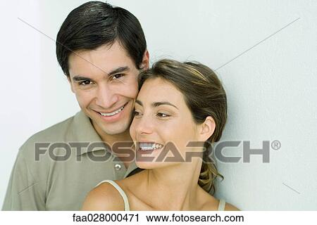 Young couple smiling, cheek to cheek, portrait View Large Photo Image Stock Image - Young couple smiling, cheek to cheek, portrait. Fotosearch